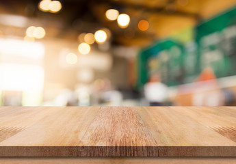 Empty wooden table top with lights bokeh on blur restaurant background