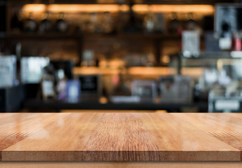 Empty wooden table top with lights bokeh on blur restaurant background
