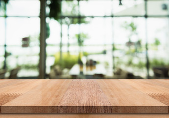 Empty wooden table top with lights bokeh on blur restaurant background