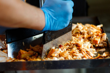 Close-up meat on special equipment, cook shawarma