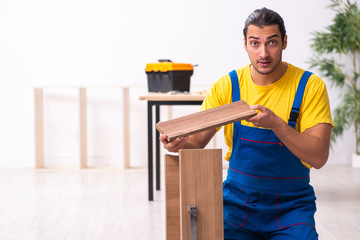 Young male carpenter working indoors