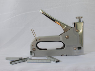 Construction iron stapler, on a white background.