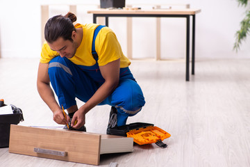 Young male carpenter working indoors