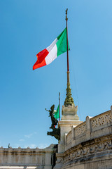 the Italian flag flies on a pole. the wind blows the canvas of the Italian flag. flags in the center of rome