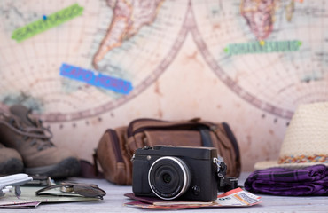 Close-up on travel accessories with map on background