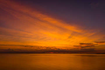 Naklejka na ściany i meble Sunset sky at the lake with clouds.