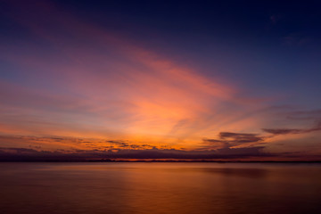 Sunset sky at the lake with clouds.
