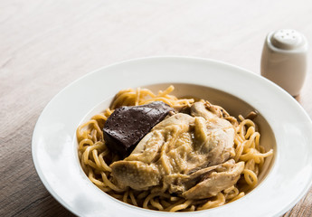 Noodles with boiled chicken in plate , Thai street food