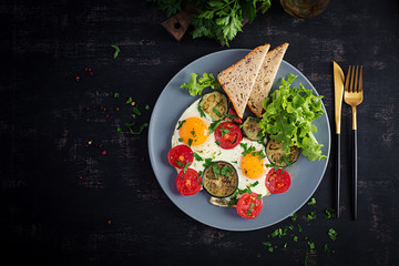 English breakfast - fried eggs, tomatoes and eggplant. American food. Top view, overhead, copy space