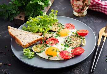 English breakfast - fried eggs, tomatoes and eggplant. American food.