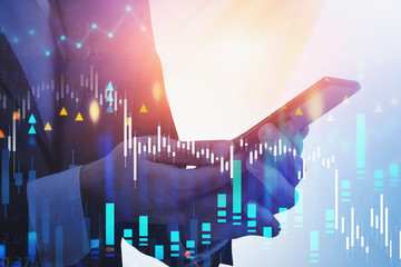 Man hands with smartphone, financial graph