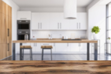 Table in blurry white and wooden kitchen