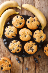 blueberry banana muffins close-up on a slate board on the table. vertical top view from above