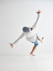 Cool young guy breakdancer jumps dancing hip-hop isolated on white background. Dance school poster. Back view