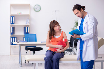 Pregnant woman visiting male doctor gynecologist