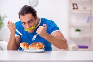 Young hungry man in dieting concept