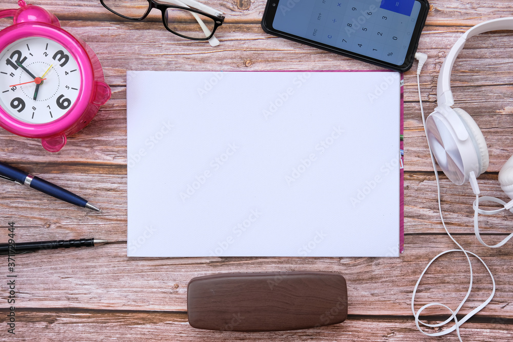 Poster smartphone and notebook on wood table and space for text