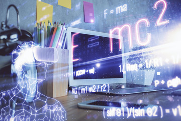 Obraz premium Desktop computer background and formula hologram writing. Double exposure. Education concept.