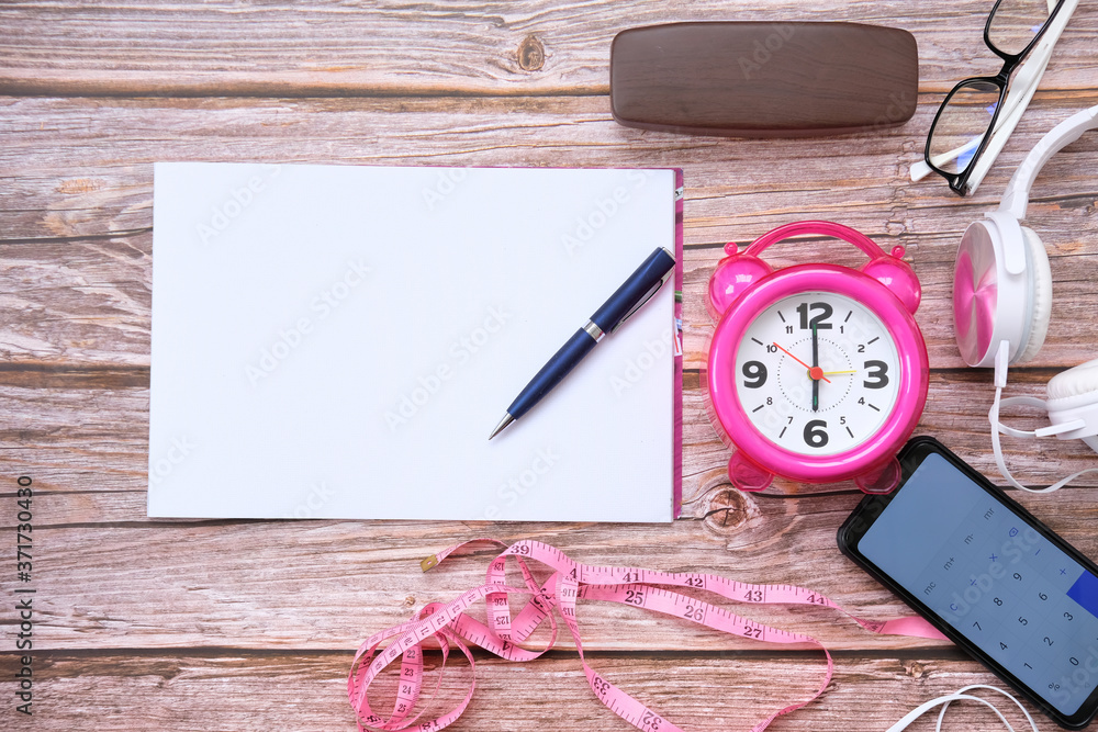 Poster Notebook and smartphone on wood table and space for text