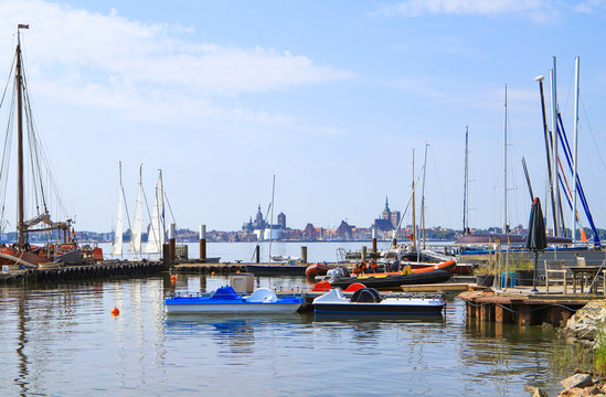 The marina of holiday destination "Altefähr" at island Rügen with the skyline of Stralsund in the background, Baltic Sea - Germany