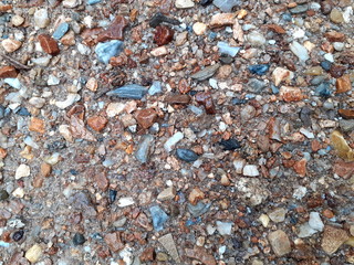Stone and gravel in river, water scenery, and long exposure surreal abstract view of a woodland, with colorful stones copy space mountain stream in countryside, Thailand.