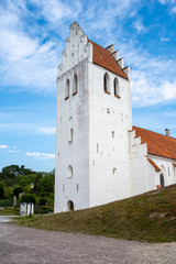 Fototapeta na wymiar The steeple tower of Falsterbo church standing almost at the beach in the south west tip of Sweden