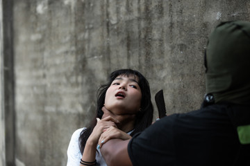 Crime concepts robbery aimed his sharp knife at an asian girl