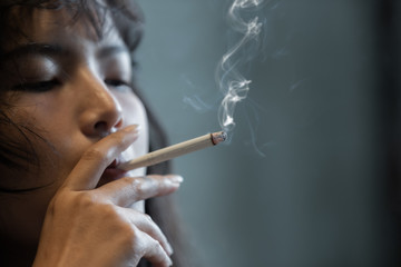 Asian girl smoking and feeling be absent-minded