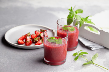 Homemade strawberry mousse dessert and plate with fresh berries on light background