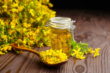Herbal infusion of Hypericum perforatum or St johns wort medicinal herb with fresh flowers