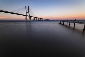 Fototapeta na wymiar The Vasco da Gama Bridge is a cable-stayed bridge flanked by viaducts and spans the Tagus River in Parque das Nações in Lisbon, the capital of Portugal. It is the longest bridge in the European Union