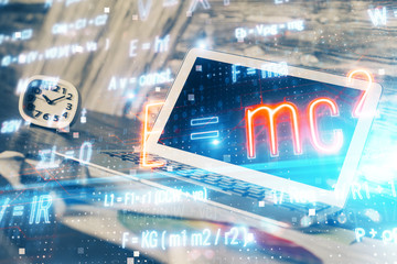 Desktop computer background and formula hologram writing. Double exposure. Education concept.