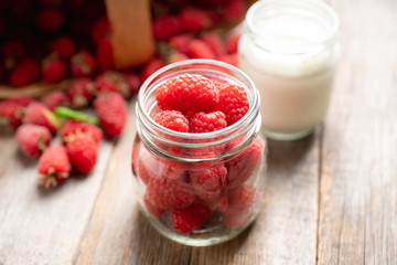 Ripe juicy raspberries in jar. Selective focus. Shallow depth of field. 