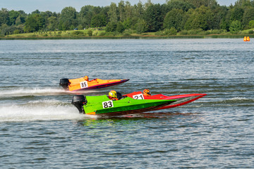 Formula boats go fast along the lake