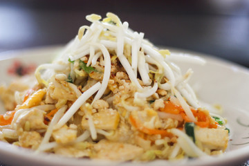 Famous traditional recipe of Thailand: Pad Thai. Made at a cooking school, it's full of chicken, vegetables, egg, etc and topped with bean shoots.