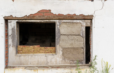 Two window openings in an old house. Brick and concrete block walls with plaster. Abandoned building concept, frame.