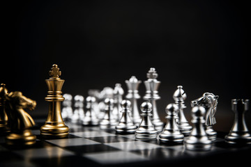 King golden chess standing confront of the silver chess team concepts of leadership and business strategy management and leadership.