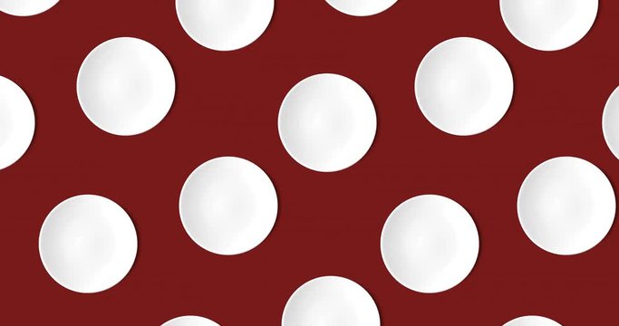 abstract pattern with many white empty plates animated on a dark red background, top view, copy space. cakes move in different directions, 4k