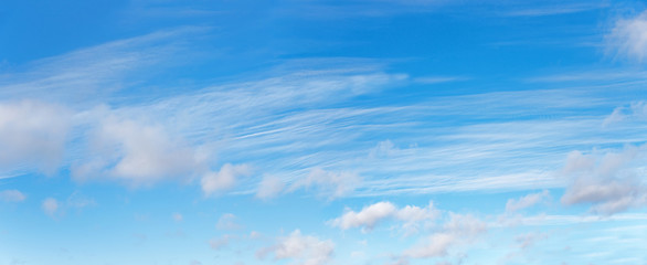 blue sky with fluffy clouds and cirrus