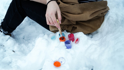 young woman in winter clothes with snow