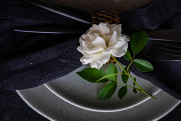 Minimalistic table setting with white rose