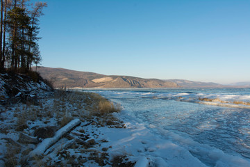 Sayan mountains in the fog on lake Baikal.