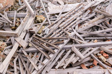 A pile of boards and bricks, wooden structures. Concept of destruction during an earthquake, explosion.
