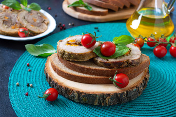 Meat rolls on rye bread with cherry tomatoes and basil. Tasty and healthy breakfast.