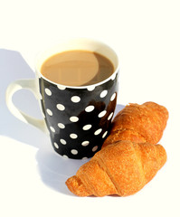Croissant with filling and coffee with milk in a beautiful cup for breakfast isolated on white background.