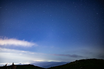 Fototapeta na wymiar 夜の伊吹山の山頂で眺める夜景と星々