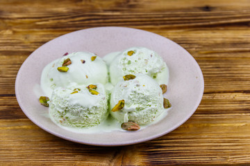 Pistachio ice cream on wooden table