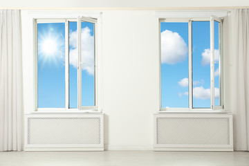 Naklejka na ściany i meble Beautiful view on blue sky with clouds through windows in room