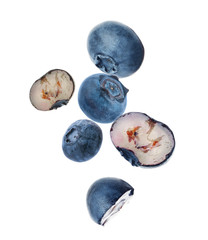 Many fresh ripe blueberries falling on white background