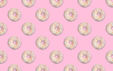 Creative pattern design of glazed donuts on pink background
